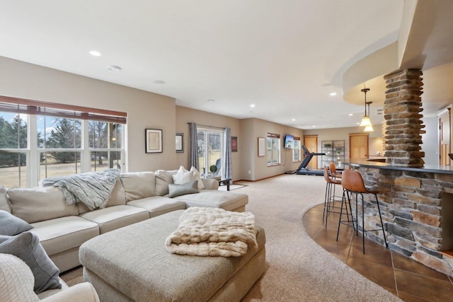 carpeted living area with tile patterned floors, recessed lighting, and baseboards