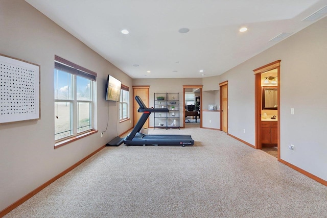 workout room with carpet flooring, recessed lighting, baseboards, and a sink