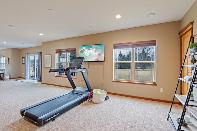 exercise room with light carpet, recessed lighting, a wealth of natural light, and baseboards