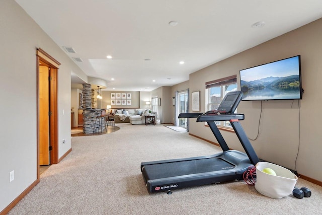 exercise area featuring visible vents, baseboards, and carpet floors