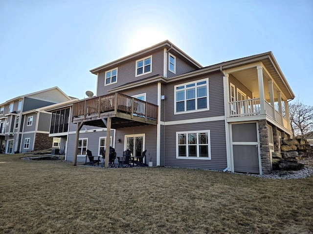 rear view of property featuring a lawn