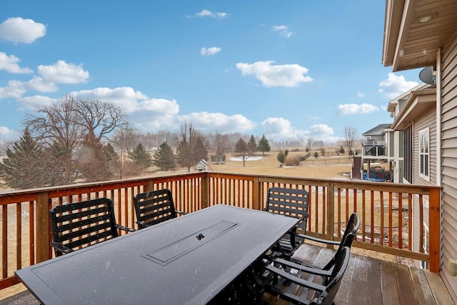 wooden terrace featuring outdoor dining area