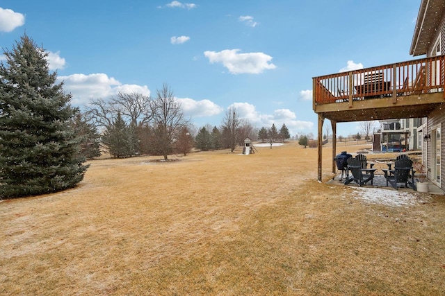 view of yard with a deck and a patio