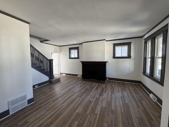 unfurnished living room featuring baseboards, visible vents, dark wood finished floors, stairs, and a fireplace