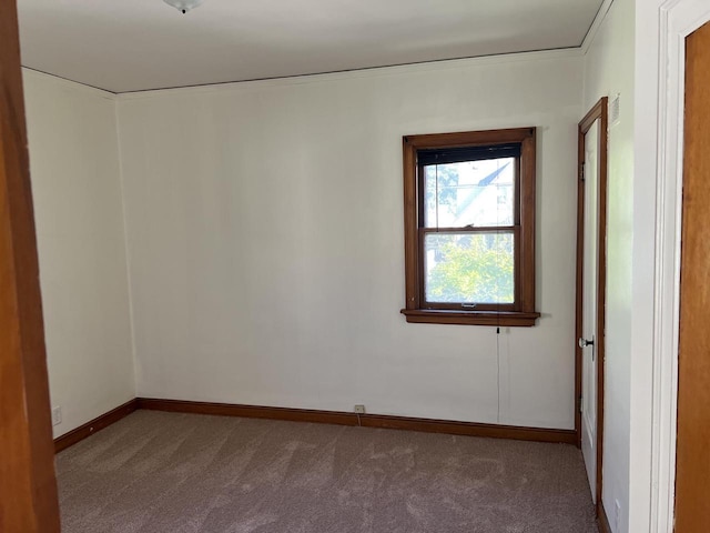 unfurnished room with carpet floors and baseboards