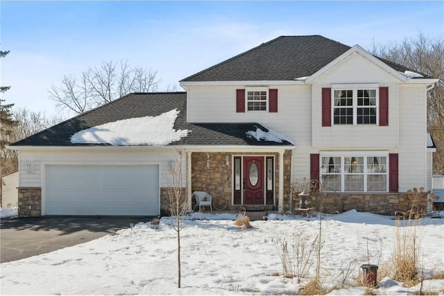 view of front of home featuring an attached garage, stone siding, driveway, and a shingled roof