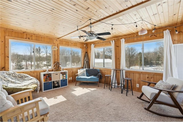 sunroom with a ceiling fan and wood ceiling