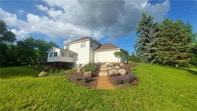 rear view of house with a yard