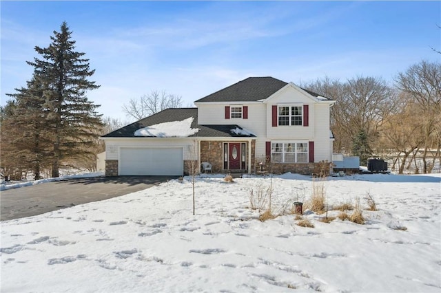 traditional home featuring stone siding and an attached garage