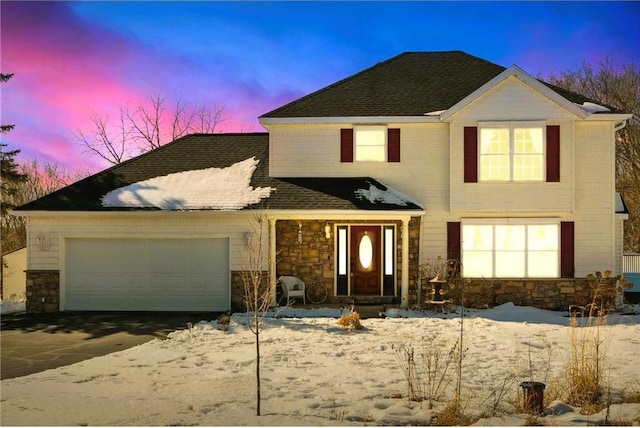 traditional-style home featuring a garage and stone siding