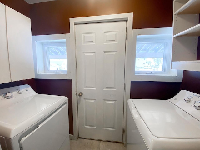 clothes washing area with washer and dryer, laundry area, and a healthy amount of sunlight