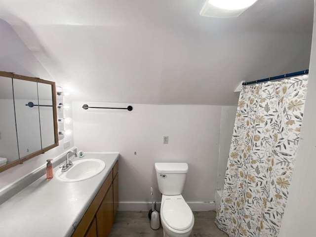 bathroom with lofted ceiling, a shower with shower curtain, vanity, and toilet