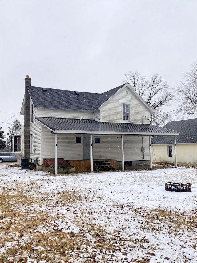 snow covered house with a chimney