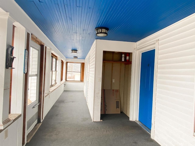 interior space featuring carpet floors and wooden ceiling