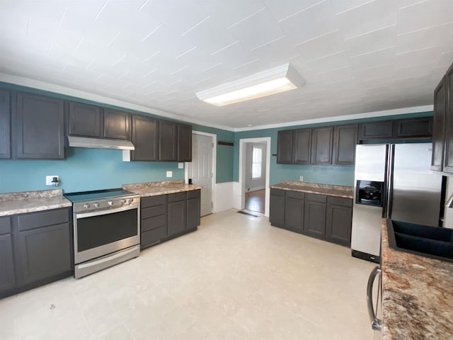 kitchen featuring stainless steel appliances, light floors, a sink, and under cabinet range hood