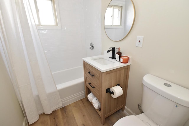 bathroom with vanity, toilet, wood finished floors, and plenty of natural light