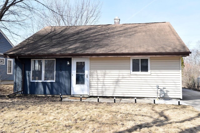 rear view of house featuring a chimney