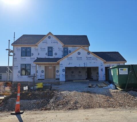 unfinished property featuring an attached garage