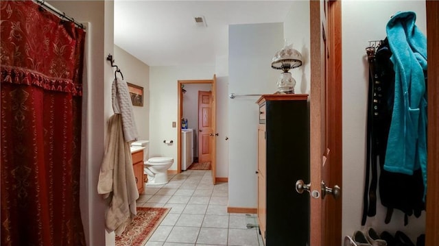 bathroom featuring visible vents, baseboards, washer / clothes dryer, curtained shower, and tile patterned flooring