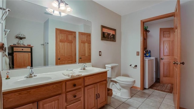 full bathroom featuring toilet, double vanity, a sink, and tile patterned floors