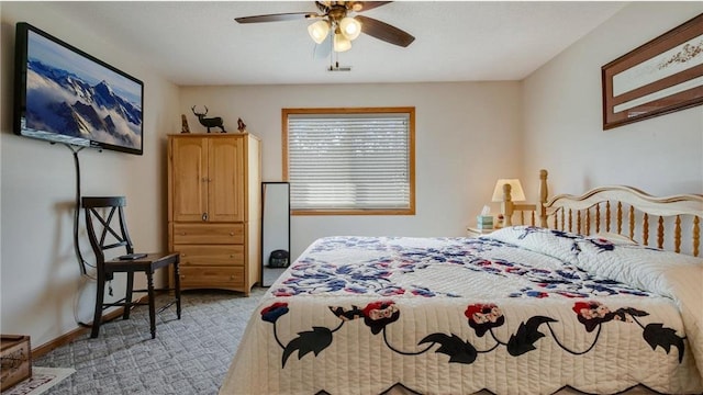 bedroom featuring light carpet, a ceiling fan, and baseboards