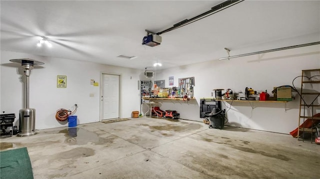 garage featuring a garage door opener and a workshop area