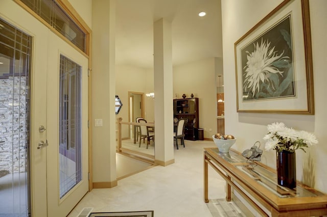 doorway with french doors, visible vents, and baseboards