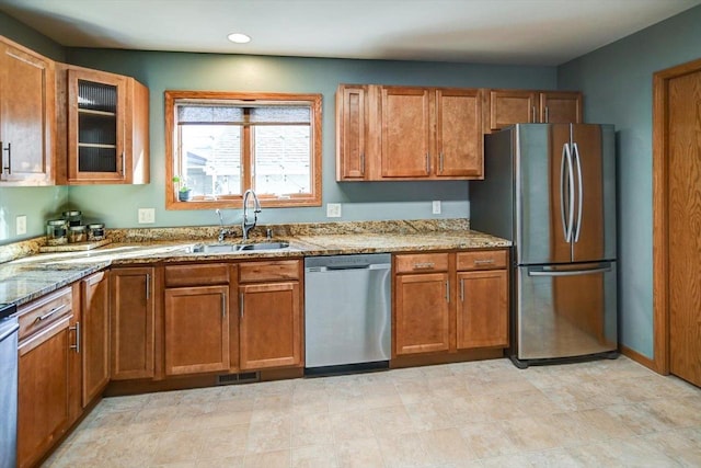 kitchen featuring a sink, brown cabinets, and stainless steel appliances