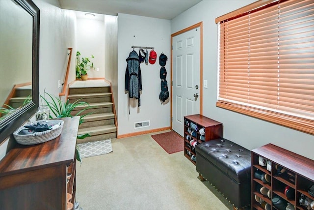 interior space with visible vents, carpet flooring, stairway, and baseboards