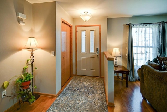 foyer featuring wood finished floors and baseboards