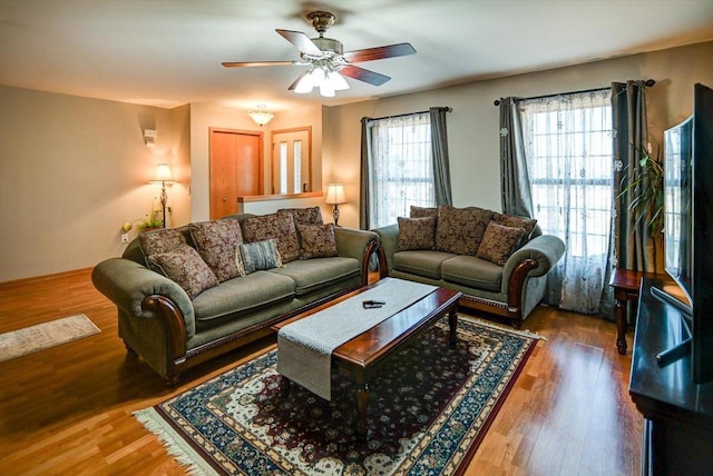 living room featuring wood finished floors and a ceiling fan