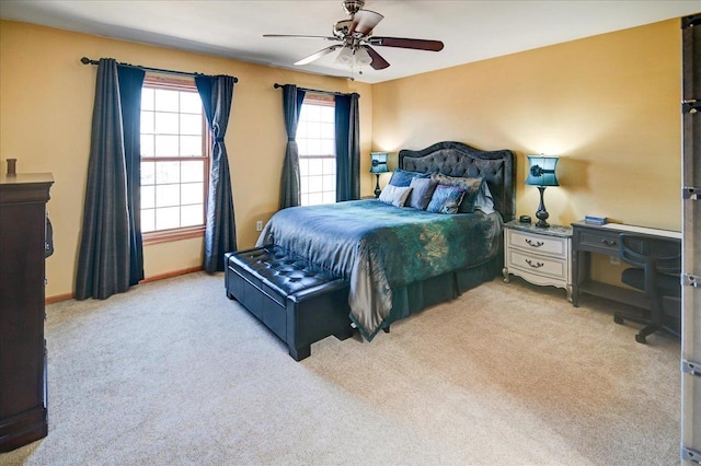 carpeted bedroom featuring a ceiling fan and baseboards