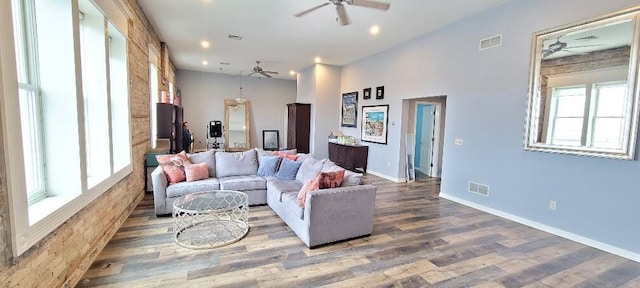 living area with ceiling fan, visible vents, and wood finished floors