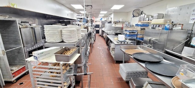 kitchen with brick floor and a drop ceiling