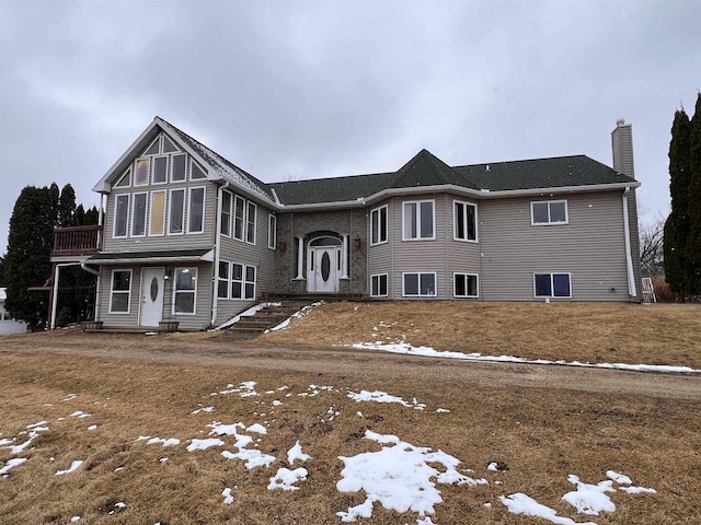 view of front of home featuring a chimney