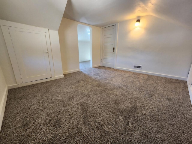 bonus room featuring visible vents, baseboards, lofted ceiling, and carpet flooring