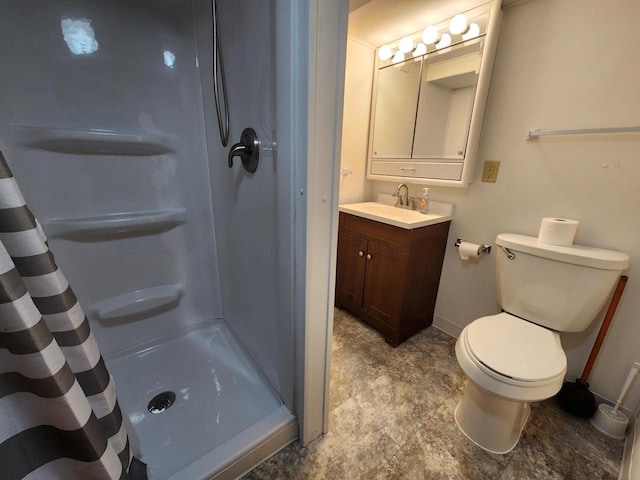 bathroom with vanity, toilet, and a stall shower