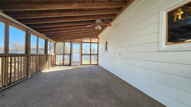 unfurnished sunroom with lofted ceiling with beams and ceiling fan