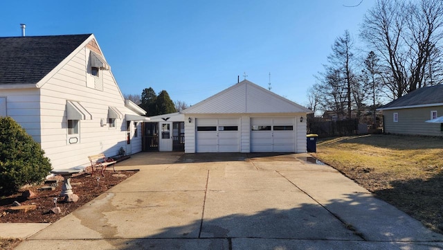 view of side of property with a garage and roof with shingles