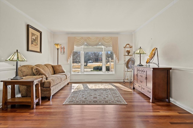 living area with baseboards, wood finished floors, and ornamental molding