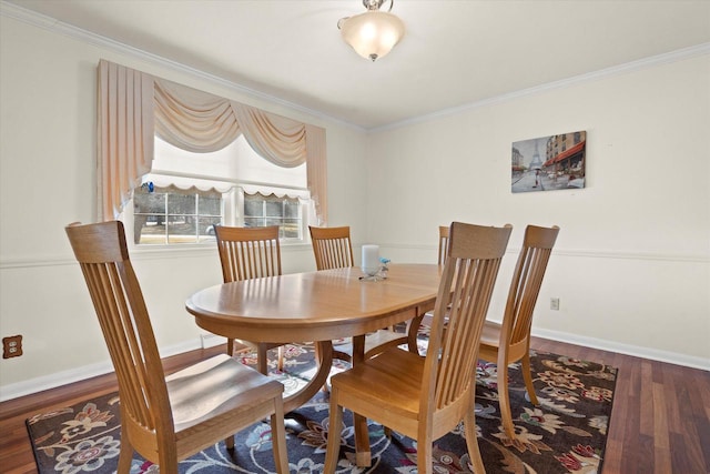 dining area featuring ornamental molding, baseboards, and wood finished floors