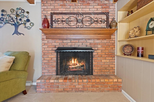 room details with a fireplace, wooden walls, built in features, and carpet