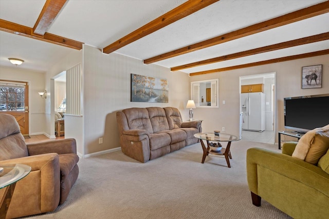 living area featuring baseboards, beam ceiling, and light carpet