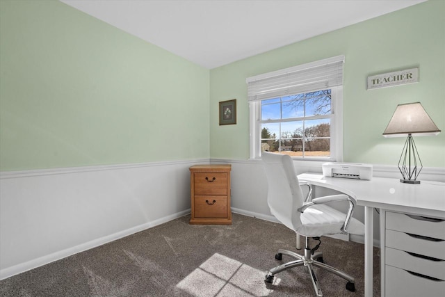 unfurnished office with baseboards and dark colored carpet