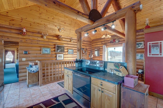 kitchen featuring dark countertops, electric range, high vaulted ceiling, and track lighting