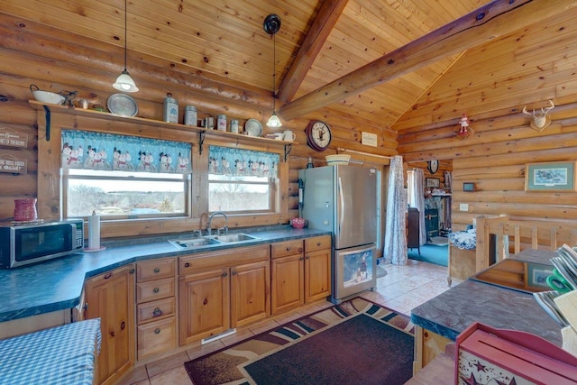 kitchen with light tile patterned floors, appliances with stainless steel finishes, a sink, pendant lighting, and beam ceiling