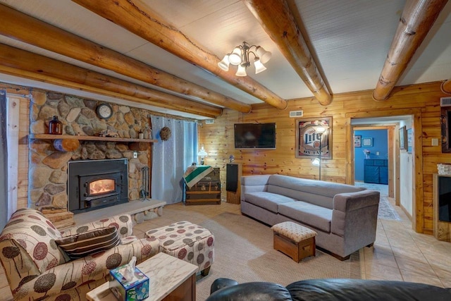 tiled living room featuring wooden walls, a fireplace, visible vents, and beam ceiling