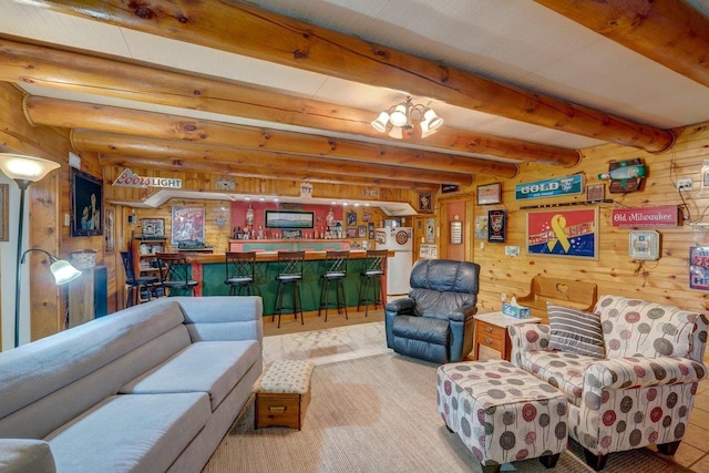 living area with beam ceiling, wood walls, and a dry bar