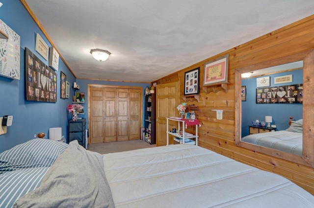 bedroom with wood walls and a closet