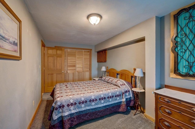 bedroom with a closet, carpet flooring, and baseboards